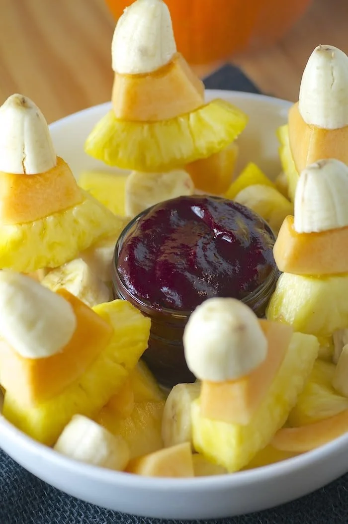 A variety of healthy Halloween snacks for kids, featuring fruits and vegetables.