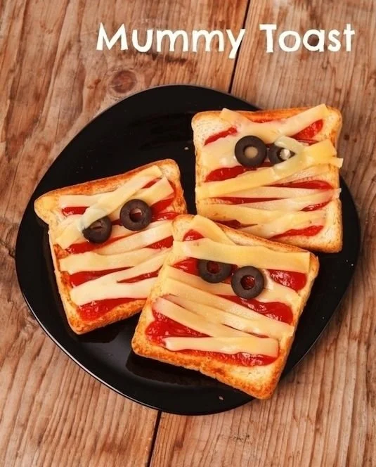 A variety of healthy Halloween snacks arranged in a festive display.