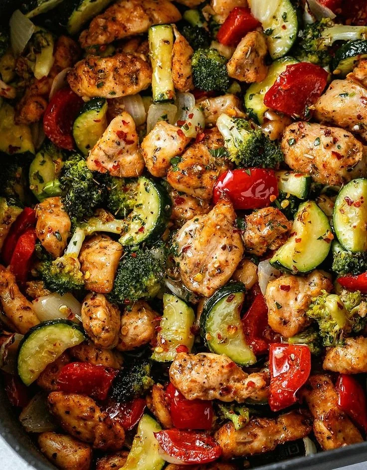 Air fryer chicken with colorful veggies on a plate, ready to serve.