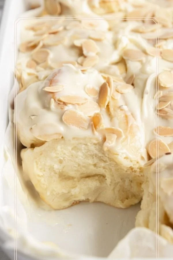 Freshly baked Almond Sweet Rolls topped with almond slices and icing
