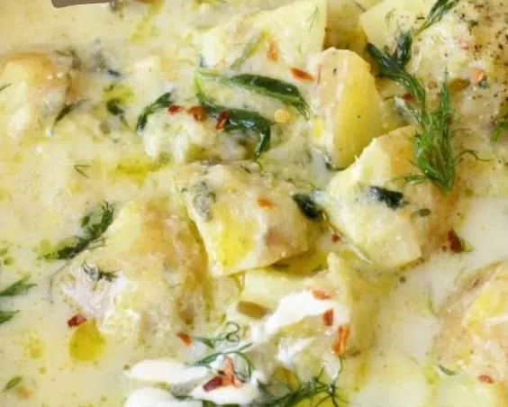 Chunky potato dill soup served in a bowl, showcasing fresh herbs and potatoes.