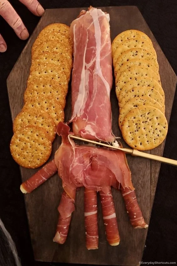 Creepy Halloween Hand Appetizer served on a platter with spooky decorations