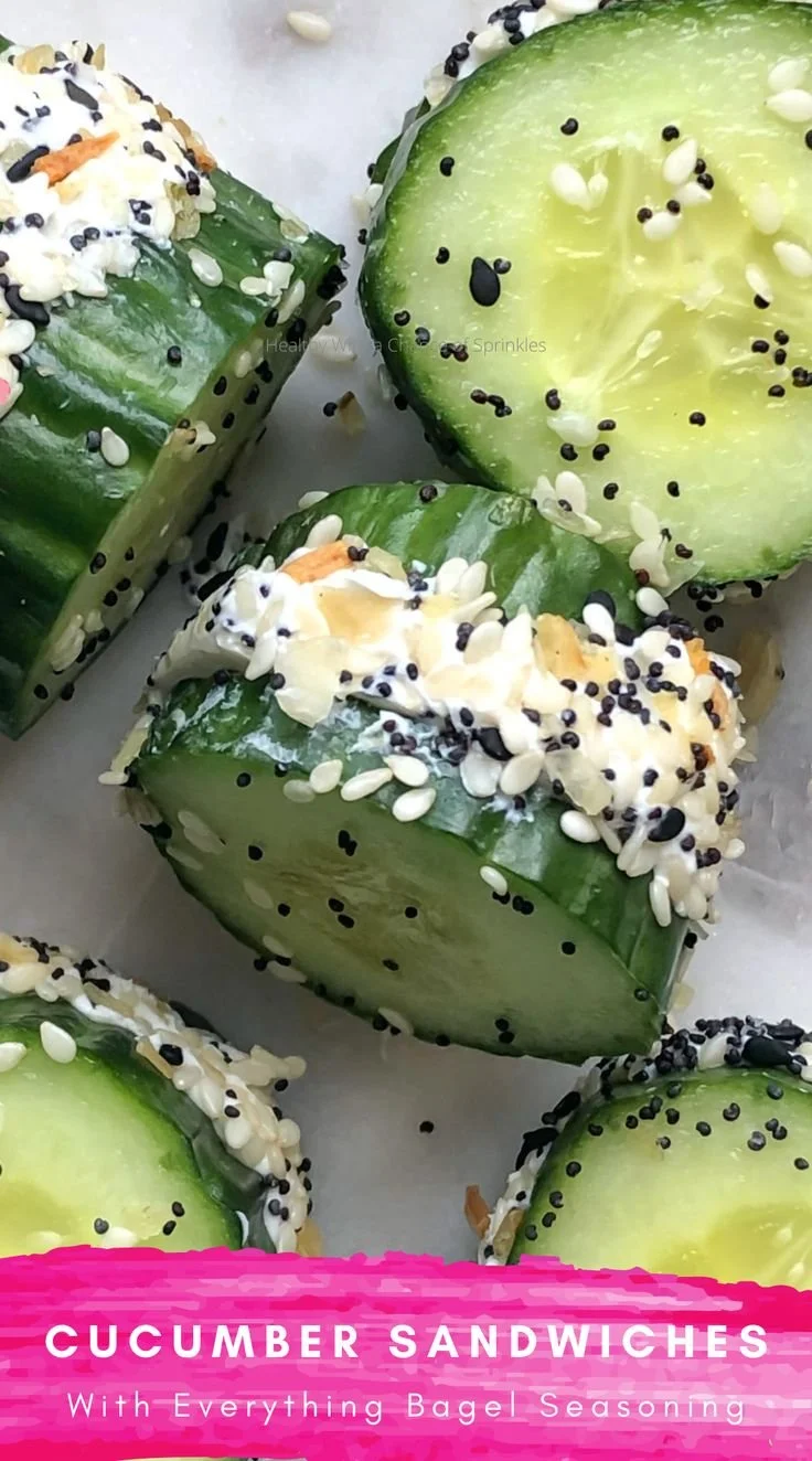 Cucumber sandwiches topped with everything bagel seasoning served on a platter