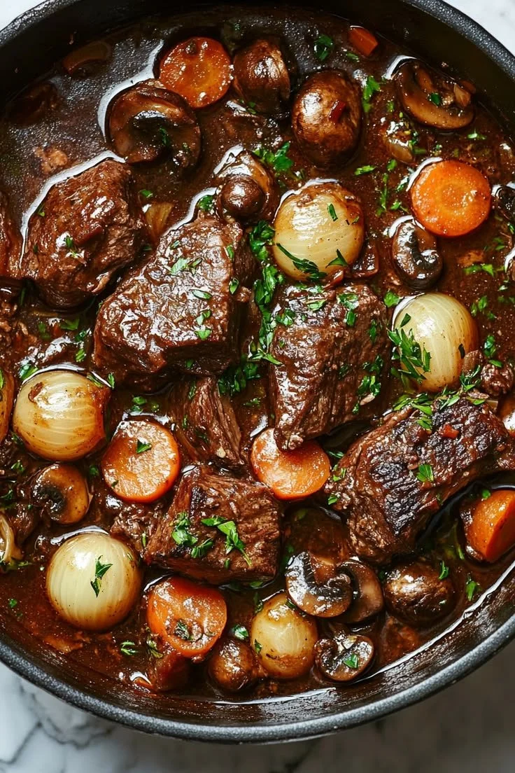 Delicious French Beef Bourguignon served in a rustic bowl with fresh herbs