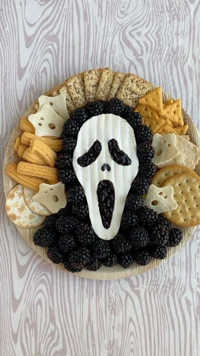 Halloween charcuterie board with spooky snacks and festive decorations
