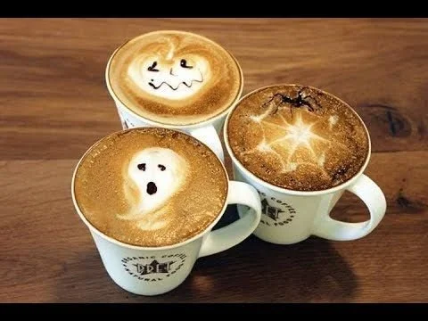 Spooky Halloween latte art featuring ghosts and pumpkins in coffee foam