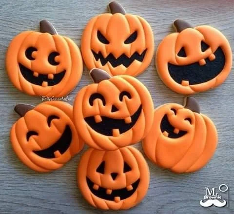Delicious homemade Halloween pumpkin cookies with festive decorations.