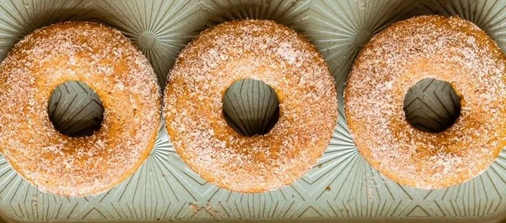 Freshly baked apple cider donuts on a rustic table
