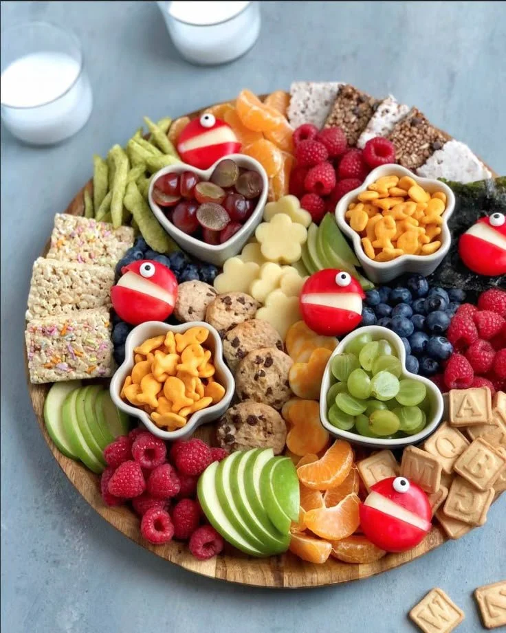 Colorful and fun Kids Charcuterie Board with fruits, cheeses, and snacks.