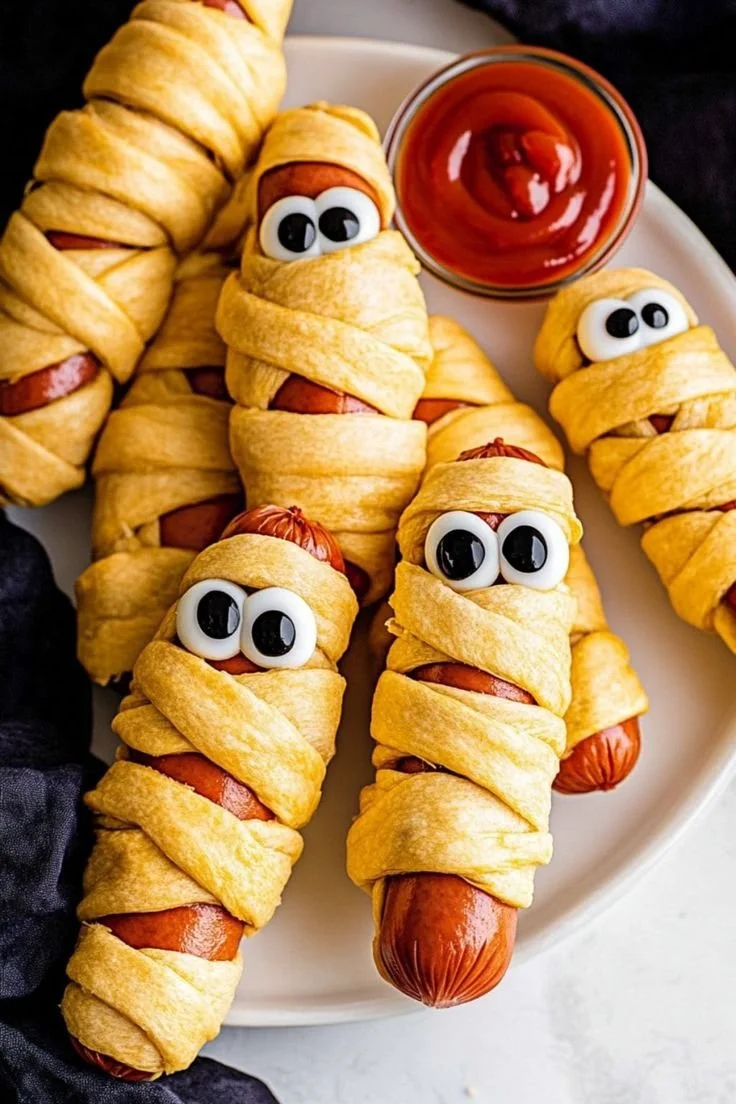 Spooky mummy hot dogs wrapped in pastry for Halloween celebration