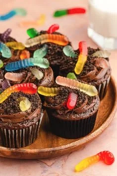 A variety of cute Halloween cupcakes decorated with spooky designs.