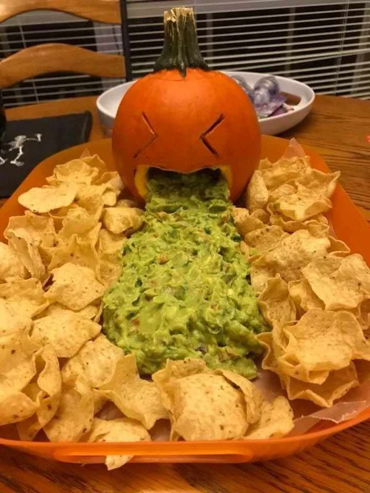 Spooky vegan Halloween treats including spider web guacamole, perfect for parties.