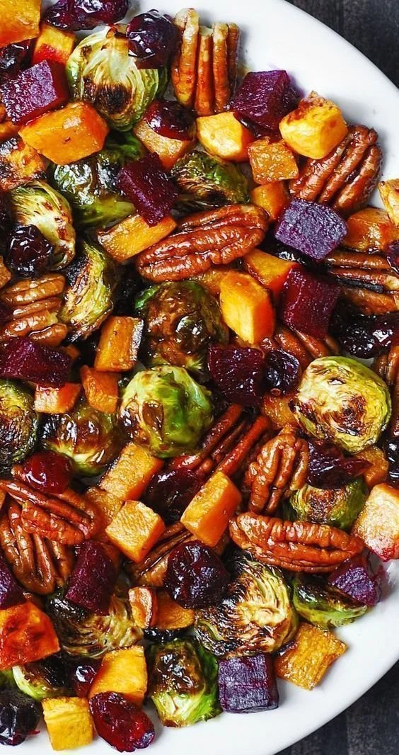 Colorful autumn salad with Brussels sprouts, cranberries, pecans, and butternut squash.
