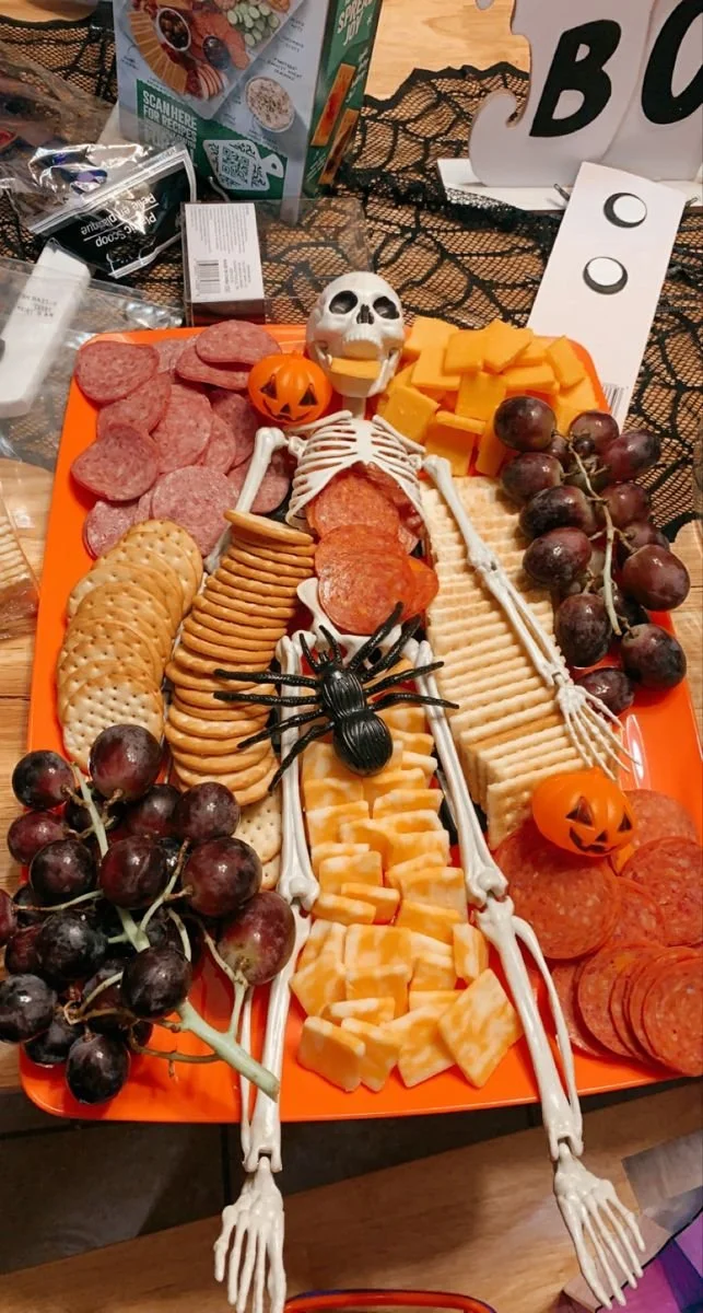 A beautifully arranged charcuterie board featuring various meats, cheeses, and fruits.