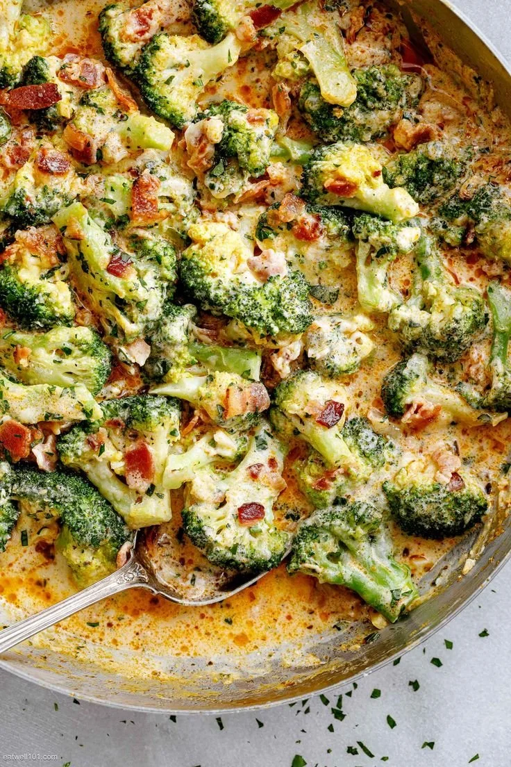 Creamy garlic parmesan broccoli with crispy bacon on a plate