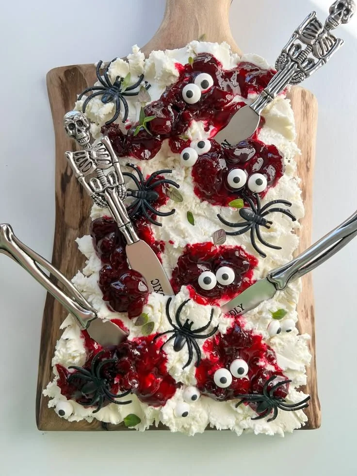 Spooky Halloween Cheese Board with festive decorations and assorted cheeses
