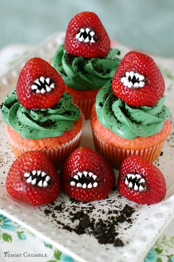 Halloween cupcakes with green frosting and strawberries for festive treats