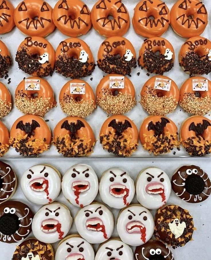 Variety of Halloween donuts decorated with spooky designs for festive treats.
