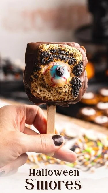 Delicious Halloween S'mores decorated with spooky themes and colors.
