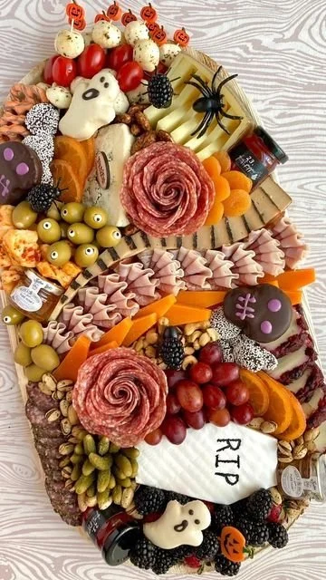 Spooky charcuterie board for Halloween buffet food at a family gathering.