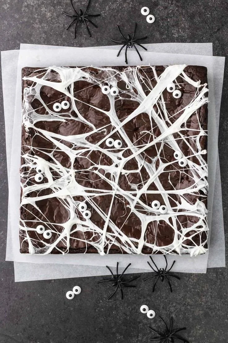 Spider Web Olive Oil Brownies topped with a web of chocolate drizzle