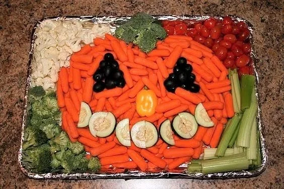 Colorful fruit and veggie tray with assorted fresh produce for a healthy snack.