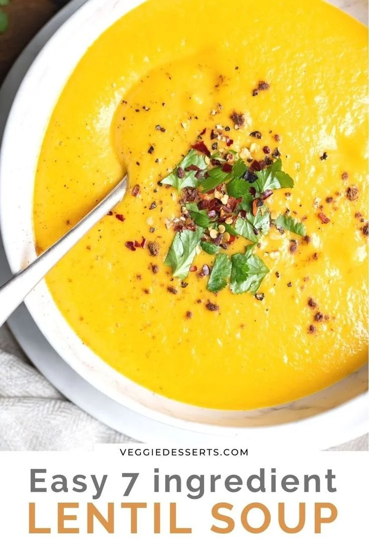 Velvety smooth blended lentil soup in a bowl garnished with herbs